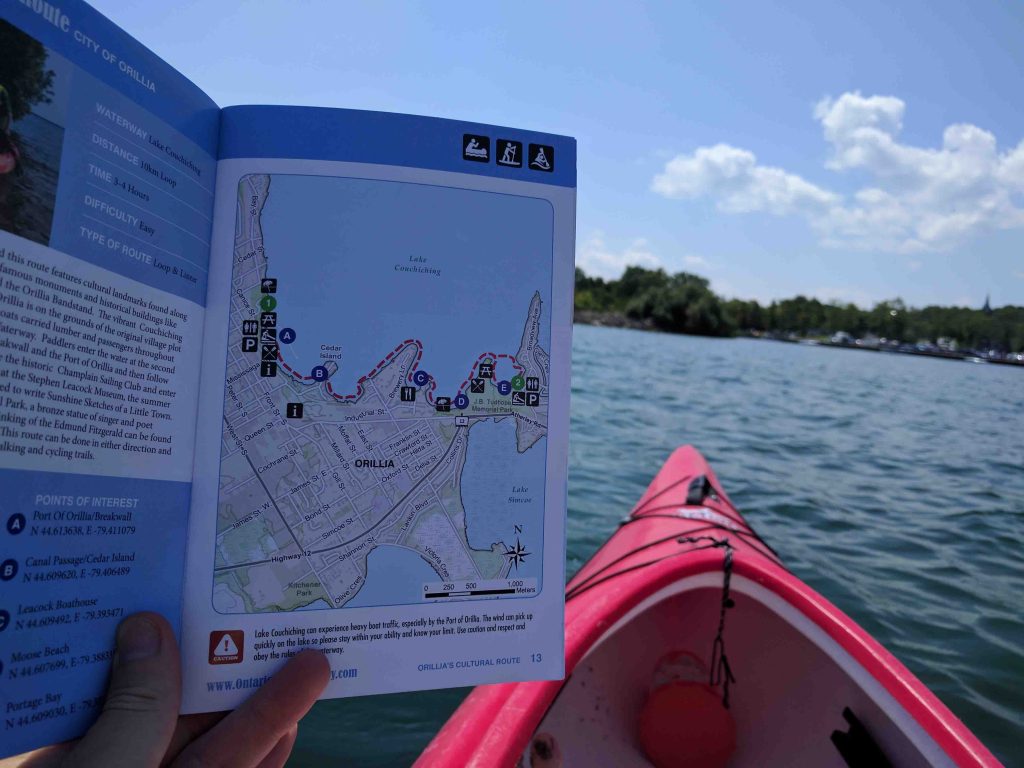 Kayak bow beside a paddling trail map