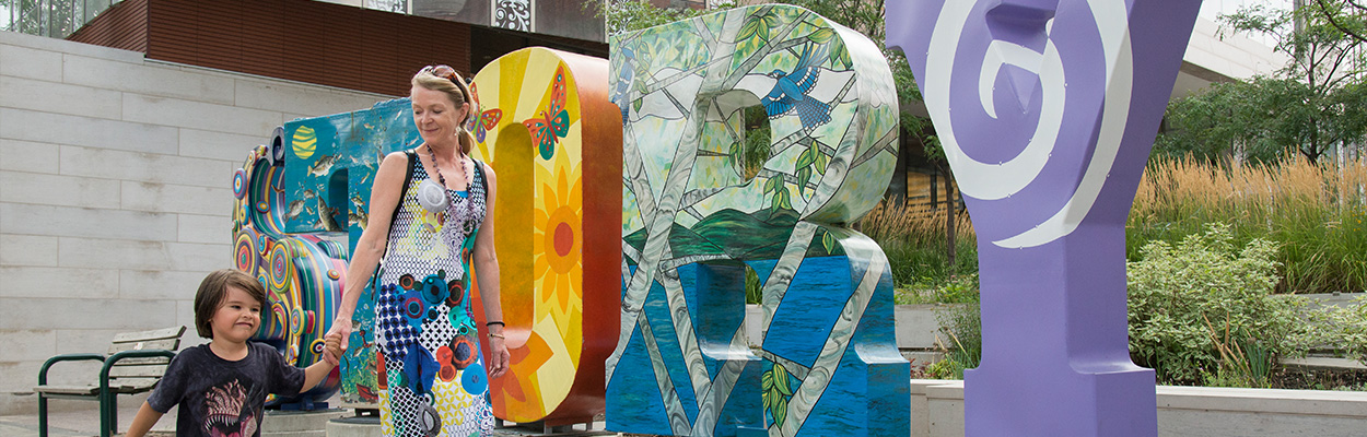 Visitors at a colourful public art installation in Orillia
