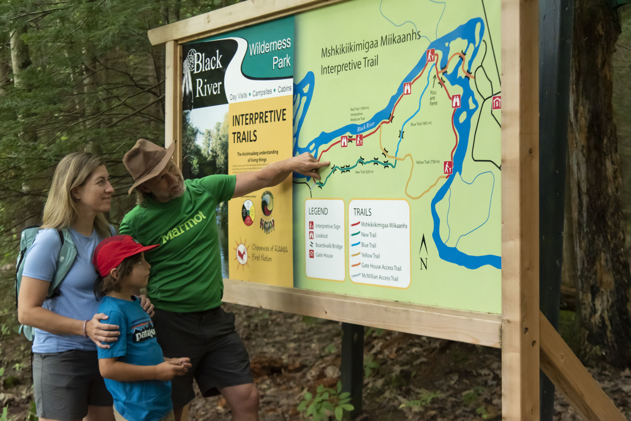 Family looking at map of trails