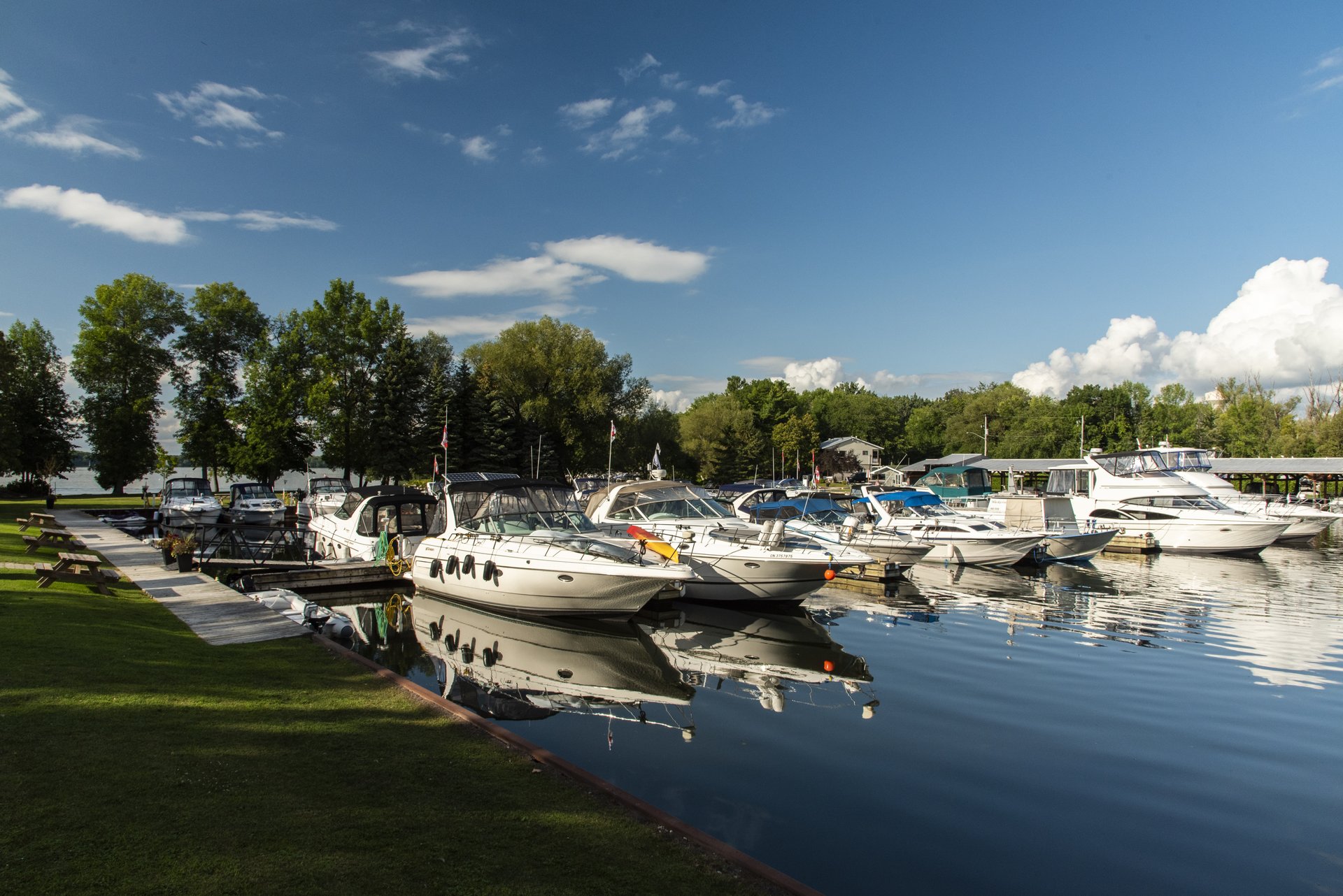 Boats docked at Ojibway Bay Marina under a blue sky