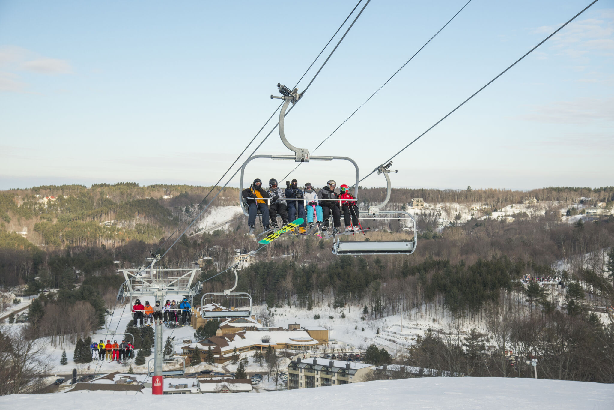 family of skiers sitting on chair lift at horseshoe resort