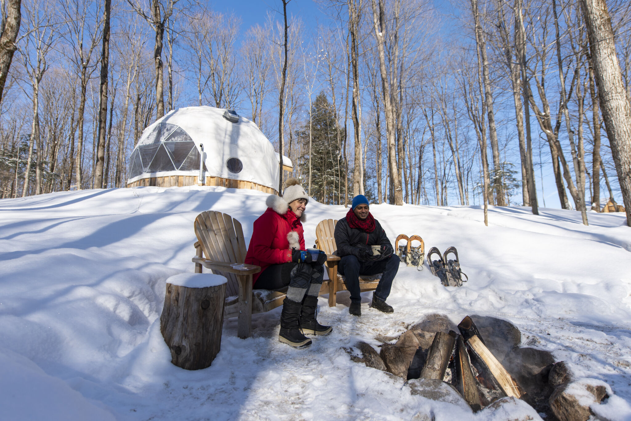 Couple around the fire after snowshoeing at Glen Oro Eco Retreat