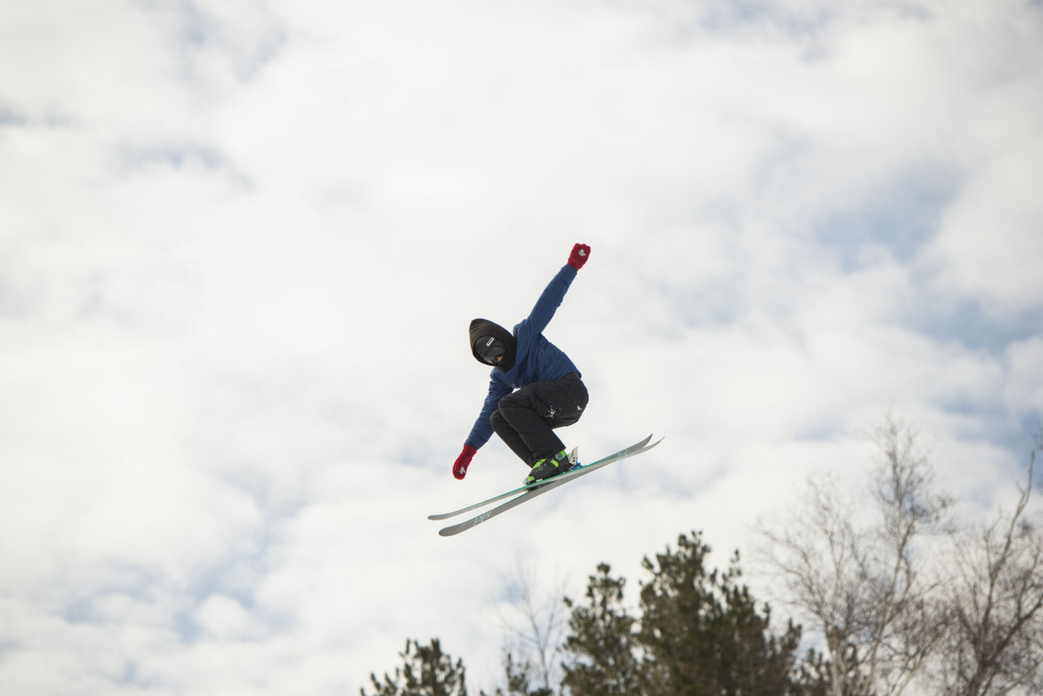 Skier jumps in the air on a downhill at Mount St Louis Moonstone