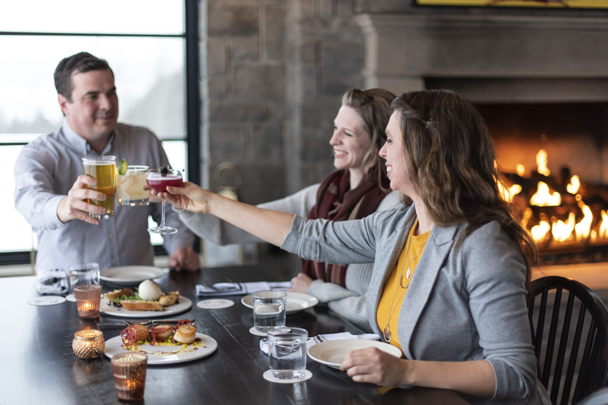 Group of friends dine and cheers over dinner at the Ktchn at the Braestone