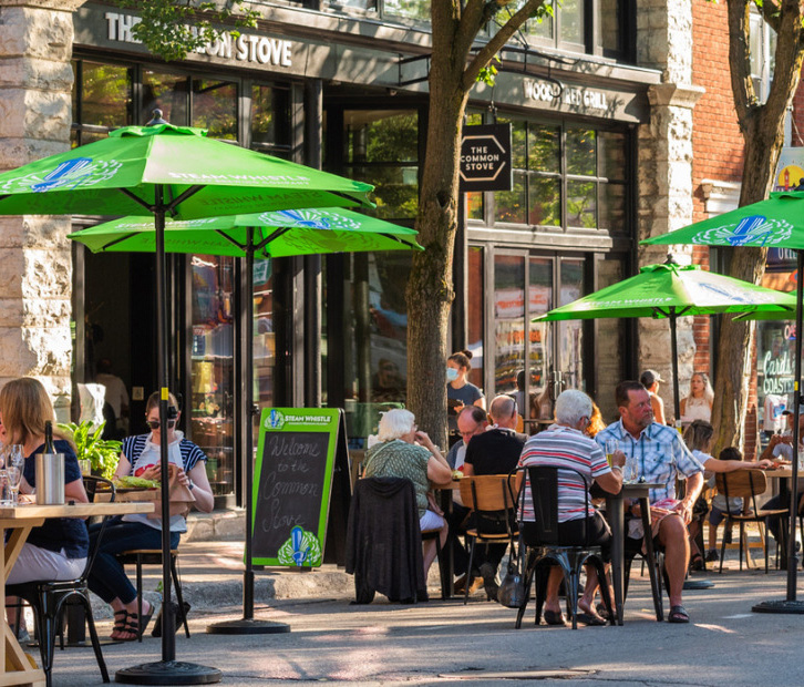 Restaurant patio with green umbrellas in downtown Orillia