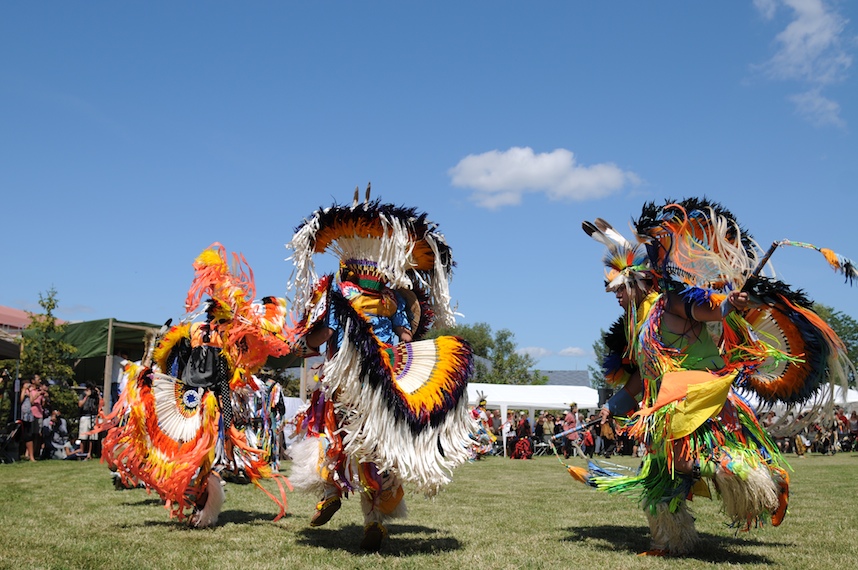 Pow wow dancers performing in colourful regalia