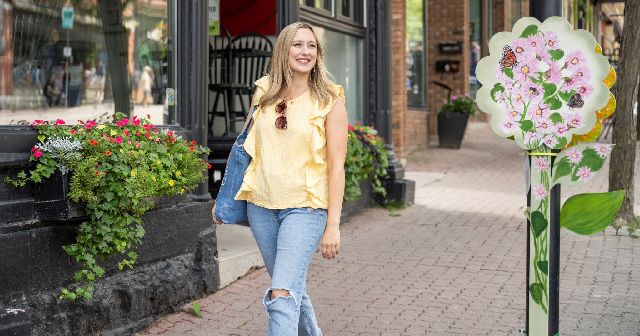 Woman walking past public art in downtown Orillia